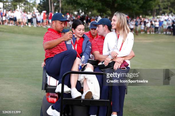 Presidents Cup golfer Xander Schauffele and his wife Maya Schauffele and Patrick Cantlay and his girlfriend Nicole Guidish ride on a golf cart after...