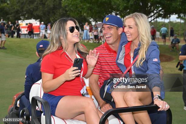 United States Team Member Billy Horschel and his wife Brittany Horschel get driven down a fairway after the final round Sunday singles matches of...