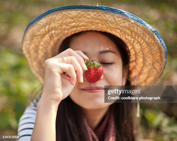 woman with strawberry infront - thailand focus 2011 stock-fotos und bilder
