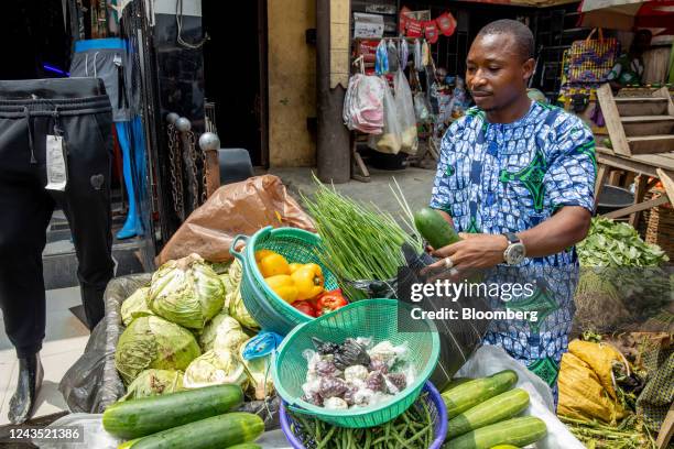 Vendor arranges a display of fresh produce on a stall at a market in Lagos, Nigeria, on Saturday, Sept. 24, 2022. Nigeria's inflation rate hit a...