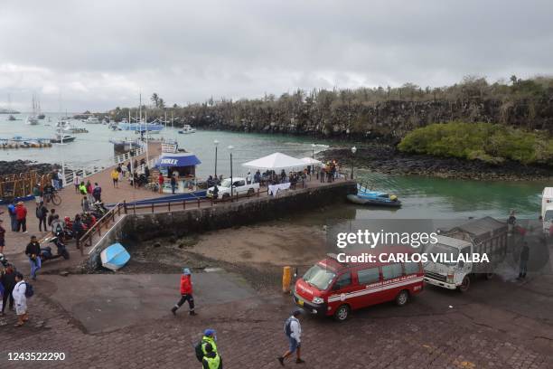 General view taken as firefighters and Navy personnel arrive with a body recovered from the sea in Puerto Ayora in Santa Cruz Island, Galapagos...