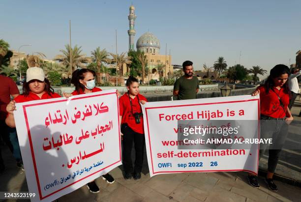 Iraqi women protest at al-Fardoos square in Baghdad on September 26, 2022 following a call by an Iraqi feminist NGO, in solidarity with Iranian women...