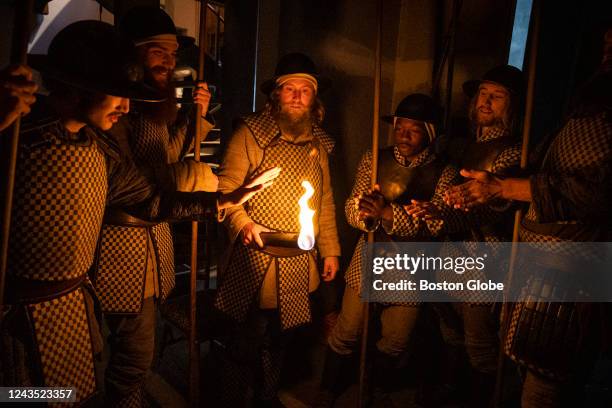 Oberammergau, Germany Temple Guards gather around a burning torch while backstage at the Passion Play.