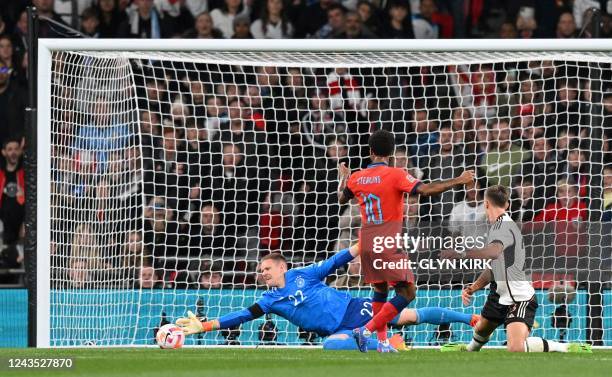 Germany's goalkeeper Marc-Andre ter Stegen dives to save a shot from England's midfielder Raheem Sterling during the UEFA Nations League group A3...