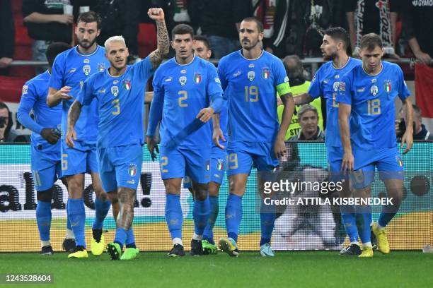 Italy's defender Federico Dimarco celebrates with teammates scoring his team's second goal during the UEFA Nations League Group 3 football match...
