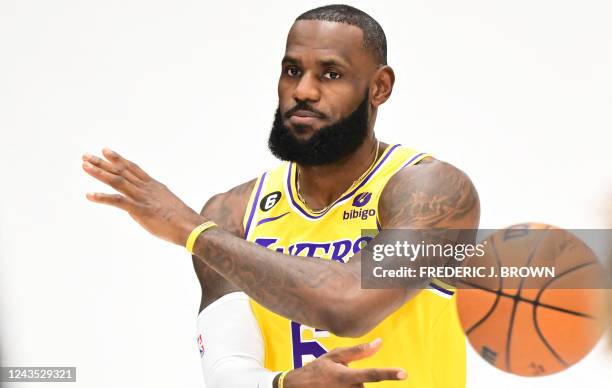 LeBron James poses with a ball at the Los Angeles Lakers media day on September 26, 2022 in El Segundo, California.