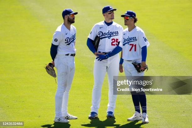 Los Angeles Dodgers outfielders Joey Gallo , left, Trayce Thompson , center, and Miguel Vargas , right, stand together during a pitching change in...