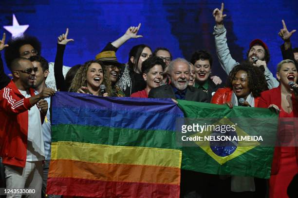 Brazilian former President and presidential candidate for the leftist Workers Party Luiz Inacio Lula da Silva holds a Brazilian flag during a meeting...