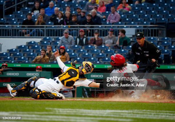 Jonathan India of the Cincinnati Reds slides in safe against José Godoy of the Pittsburgh Pirates in the first inning during the game at PNC Park on...