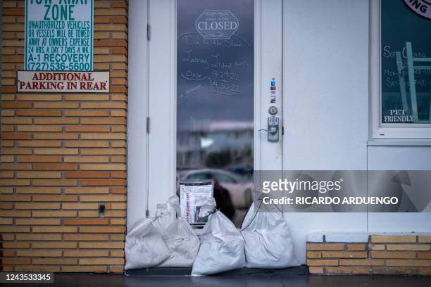 Sandbags are set up in front of a cafe as a flood precaution for Hurricane Ian in St. Pete Beach, Florida on September 26, 2022. In Florida, the city...