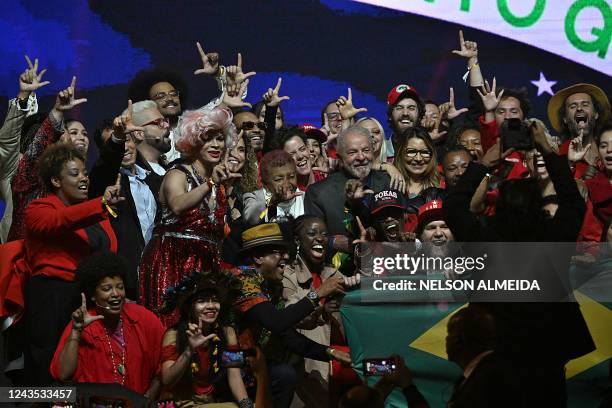 Brazilian former President and presidential candidate for the leftist Workers Party Luiz Inacio Lula da Silva holds a Brazilian flag during a meeting...