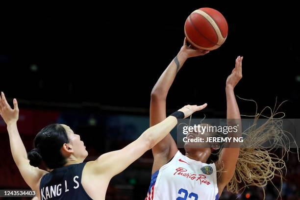 Puerto Rico's Arella Guirantes shoots under pressure from South Korea's Kang Lee-seul during the Women's Basketball World Cup group A game between...