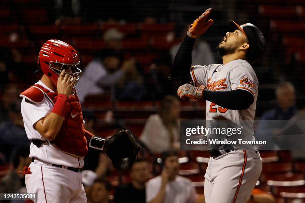 Anthony Santander of the Baltimore Orioles celebrates his solo home run in the sixth inning at the plate as catcher Reese McGuire of the Boston Red...