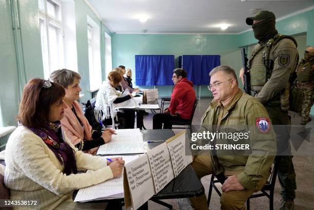 Konstantin Ivashchenko , former CEO of the Azovmash plant and appointed pro-Russian mayor of Mariupol, visits a polling station as people vote in a...