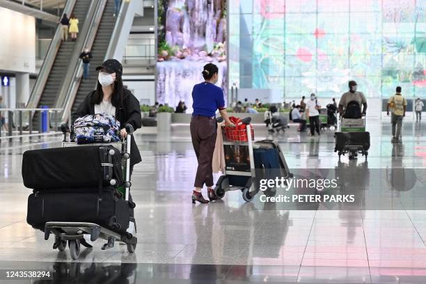 Travellers arrive at Hong Kong's international airport on September 27, 2022. - Hong Kong on September 26 ended mandatory hotel quarantine, scrapping...
