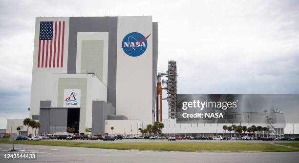 In this handout image provided by NASA, NASAs Space Launch System rocket with the Orion spacecraft aboard is seen atop the mobile launcher as it is...