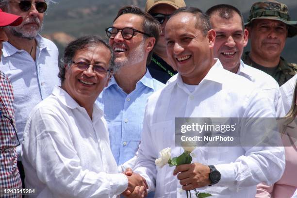 Colombian President Gustavo Petro shakes hands with Venezuelan Transport Minister Ramon Velasquez during the official reopening ceremony of the...