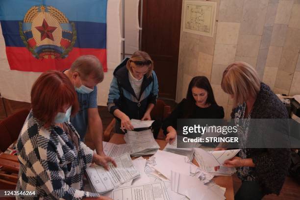 Election commission members count votes of refugees from Russian-held regions of Ukraine for a referendum at a polling station in Simferopol, Crimea,...