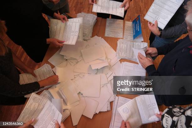 Election commission members count votes of refugees from Russian-held regions of Ukraine for a referendum at a polling station in Simferopol, Crimea,...