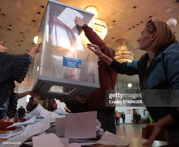 Election commission members count votes of refugees from Russian-held regions of Ukraine for a referendum at a polling station in Simferopol, Crimea,...