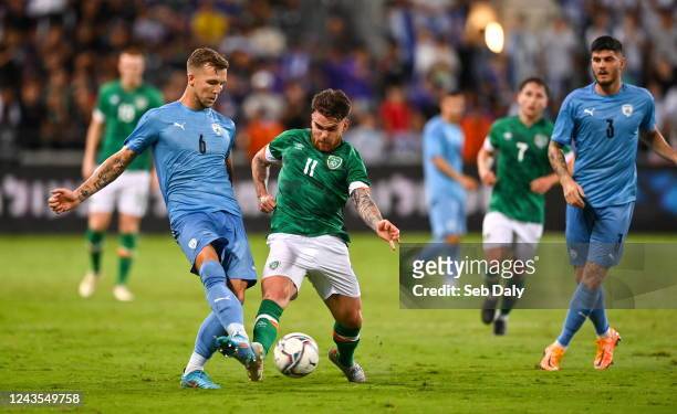 Tel Aviv , Israel - 27 September 2022; Eden Karzev of Israel is tackled by Aaron Connolly of Republic of Ireland during the UEFA European U21...