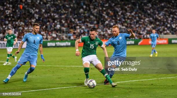 Tel Aviv , Israel - 27 September 2022; Andy Lyons of Republic of Ireland in action against Eden Karzev and Ido Shahar of Israel during the UEFA...