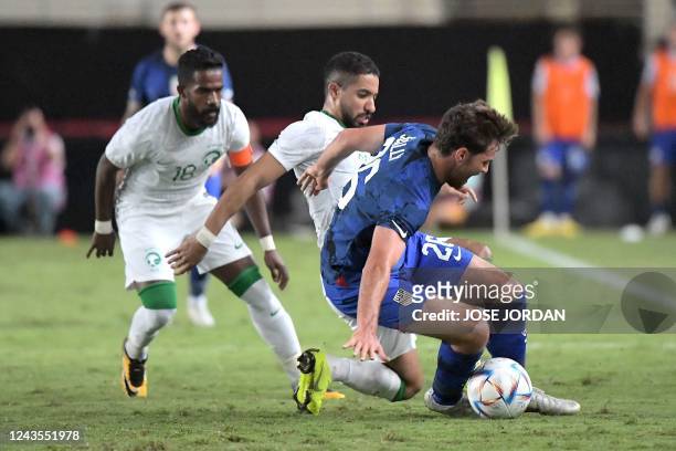Defender Joe Scally is challenged by Saudi Arabia's midfielder Hattan Bahebri during the friendly football match between Saudi Arabia and United...