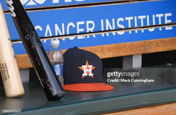 Houston Astros baseball hat and bats sit on the dugout bench during the game against the Detroit Tigers at Comerica Park on September 14, 2022 in...