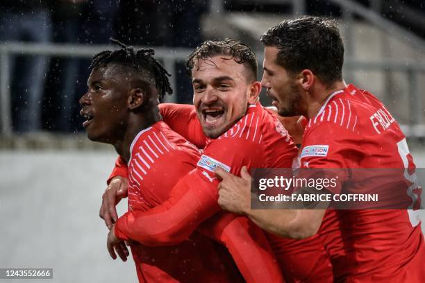 Switzerland's forward Breel Embolo celebrates scoring the 2-0 goal with teammates midfielder Xherdan Shaqiri and midfielder Remo Freuler , who scored...