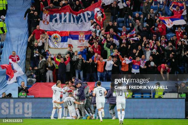 Serbia's players cheer in front of their supporters after Serbia's forward Aleksandar Mitrovic scored 0-2 during the UEFA Nations League Group 4...