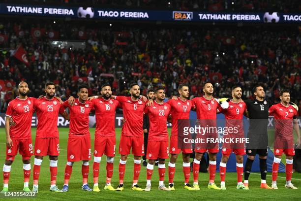 Tunisia's players listen to the national anthems prior to the friendly football match between Brazil and Tunisia at the Parc des Princes in Paris on...