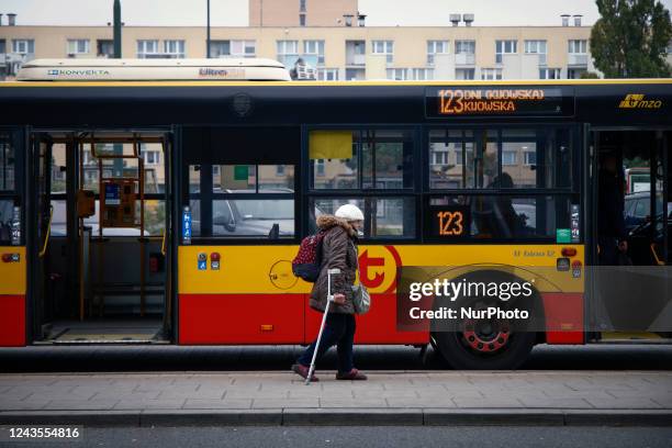 An elderly woman with crutches walks past a bus at the Warsaw East railway station in Warsaw, Poland on 27 September, 2022. Poland's agein population...