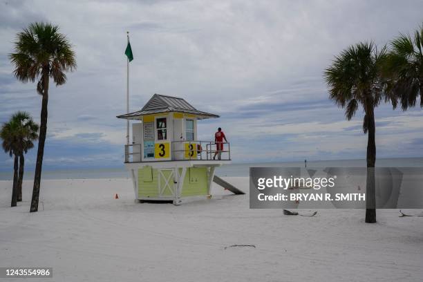 Lifeguard looks from his post on Clearwater Beach ahead of Hurricane Ian on September 27, 2022 in Clearwater. - The US National Hurricane Center said...