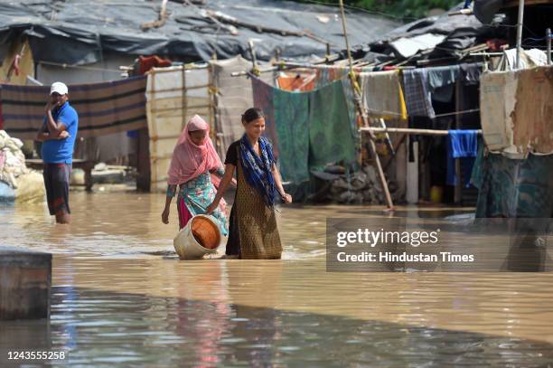 Residents living along the bank of Yamuna river relocated to higher grounds as the water level started to flow above the danger level on September...