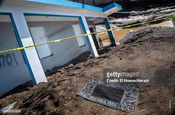 Welcome mat lies in front of a house that collapsed into a sink hole after flooding from the Nigua River during Hurricane Fiona at Villa Esperanza in...