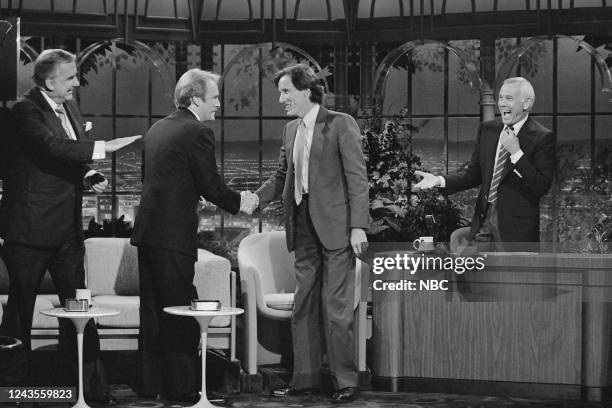 Pictured: Announcer Ed McMahon and actor Martin Mull greet actor James Woods during an interview with host Johnny Carson on October 8, 1981 --