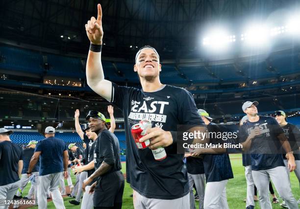 Aaron Judge of the New York Yankees celebrates on field after his team defeated the Toronto Blue Jays to clinch first place in the AL East following...