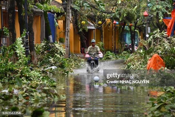 Man rides a motorbike in a flooded street following the passage of typhoon Noru in Hoi An city, Quang Nam province on September 28, 2022.