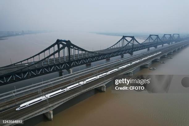 An aerial view shows a high-speed train passing by the Pengbu Bridge in Hangzhou, Zhejiang province, China, on Sept 28, 2022. Hangzhou Pengbu Bridge...