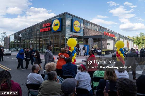 People gather for a grand opening at a Lidl, the first full service supermarket to open east of the Anacostia River to open in 15 years, on September...