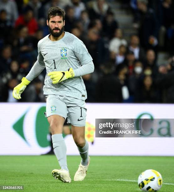 Brazil's goalkeeper Alisson passes the ball during the friendly football match between Brazil and Tunisia at the Parc des Princes in Paris on...