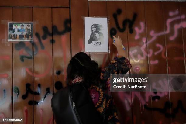 Members of the Iranian community in Mexico, stick banners on the doors of the Embassy of the Islamic Republic of Iran in Mexico City, while...