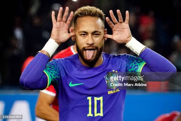 Neymar of Brazil celebrates scoring a goal from the penalty spot during the International Friendly between Brazil and Tunisia at Parc des Princes on...