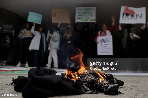 Members of the Iranian community in Mexico burned a veil outside the Embassy of the Islamic Republic of Iran in Mexico City in protest against the...