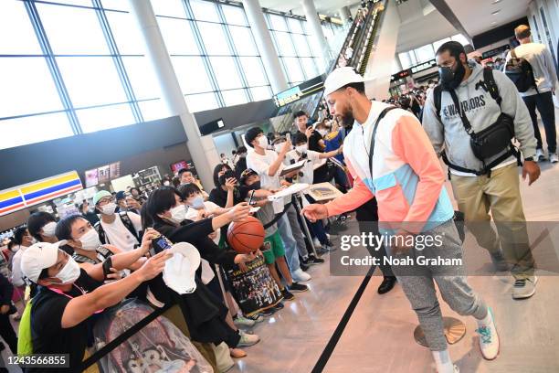 Stephen Curry of the Golden State Warriors signs autographs for fans as he arrives in Japan for the 2022 NBA Japan Games on September 28, 2022 in...