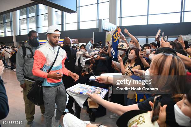 Stephen Curry of the Golden State Warriors signs autographs for fans as he arrives in Japan for the 2022 NBA Japan Games on September 28, 2022 in...