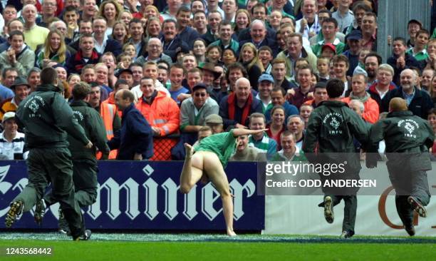Stewards chases a streaker during a Six-Nations Rugby Union match between England and Ireland at Lansdowne Road in Dublin , 20 October 2001.England...