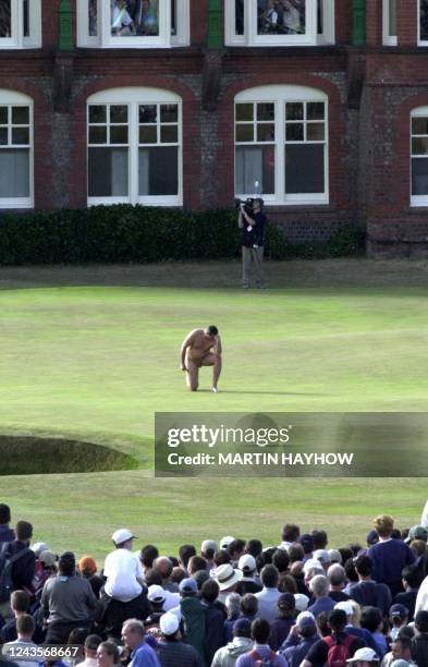 Male streaker strikes a pose on the 18th green in front of the clubhouse, 22 July 2001, just seconds after David Duval won the Open Golf Championship...