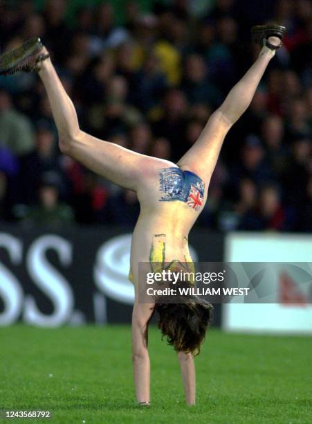 Female streaker with the Australian flag painted on her bottom does a cartwheel during the Australia versus Romania clash at the1999 Rugby World Cup...