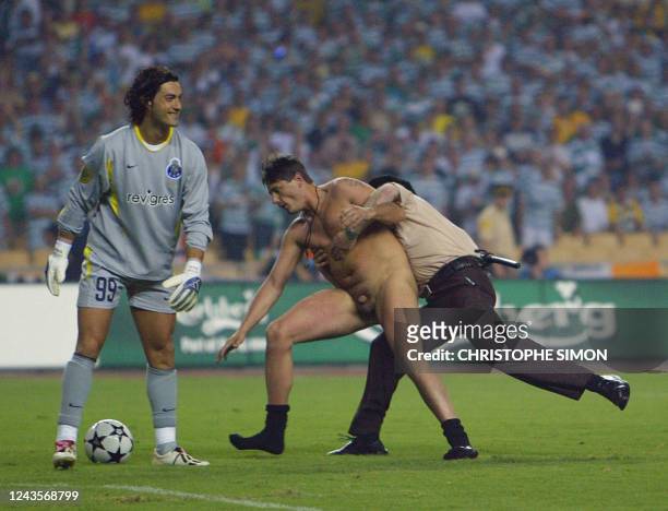 A security guard catches a streaker in front of Fc Porto goalkeeper Vitor Baia during the soccer UEFA Final Cup between Celtic FC and FC Porto, 21...
